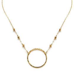 14k gold filled xl unity beaded necklace with a gold circle pendant on a white surface