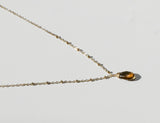 side view of beer quartz and gold pendant necklace