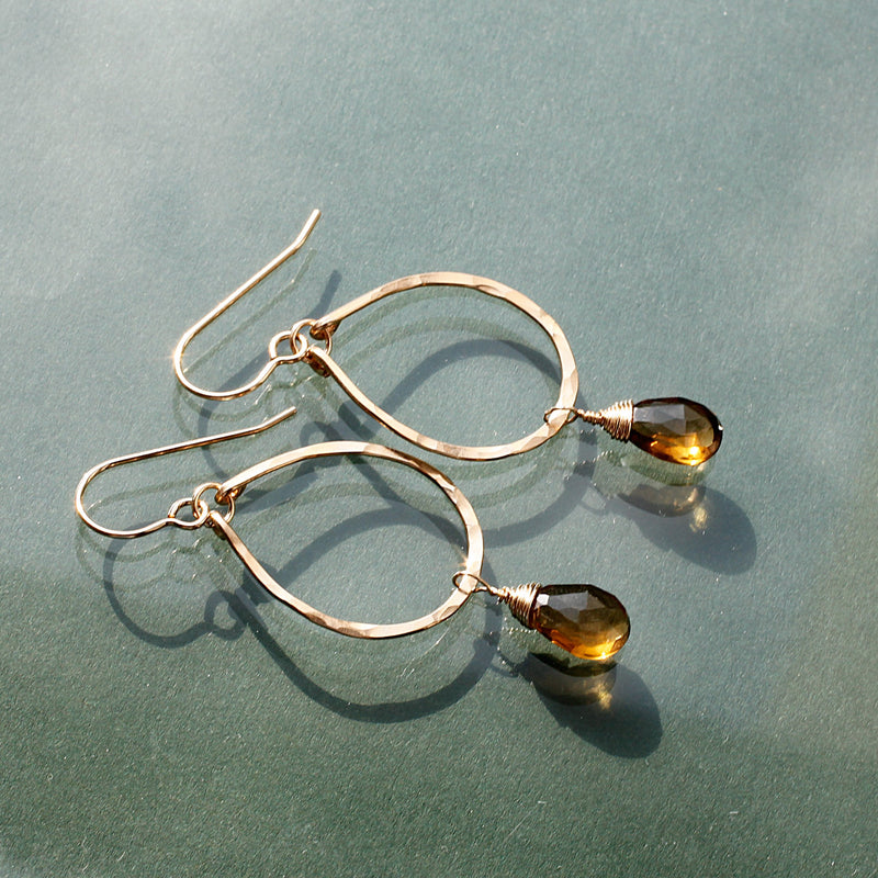 side view of beer quartz and gold teardrop earrings by delia langan jewelry