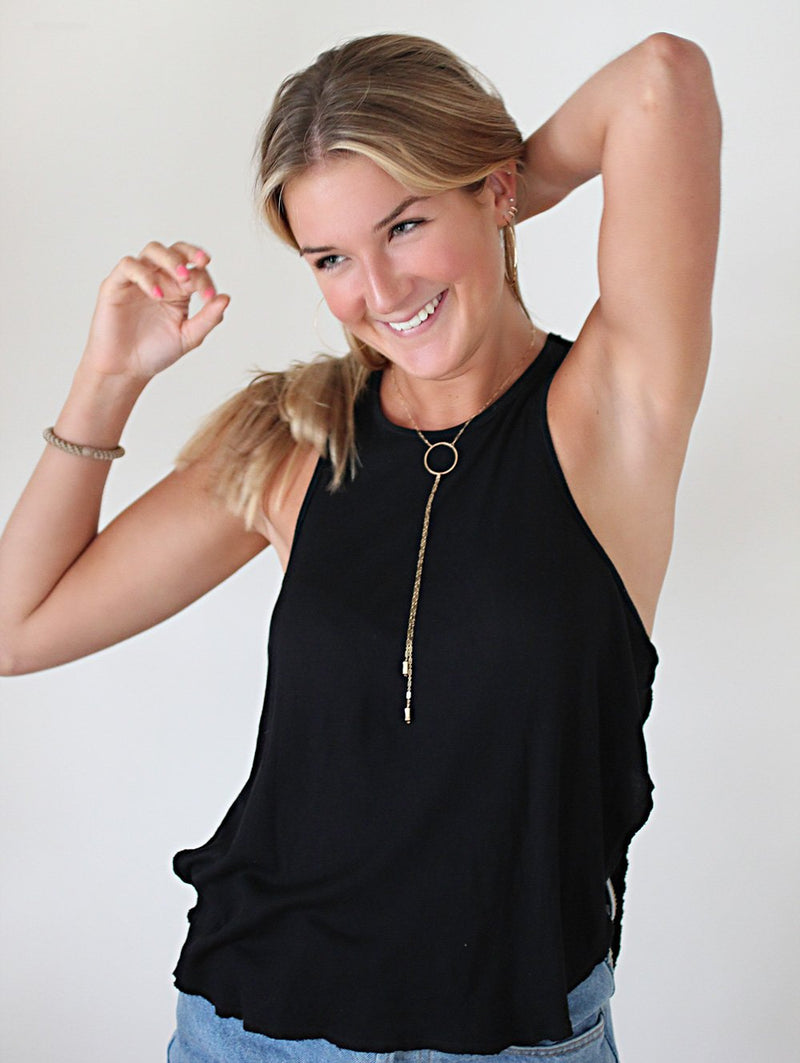 blond woman on a black tshirt smiling and looking to the side wearing a 14k gold filled bolo y necklace