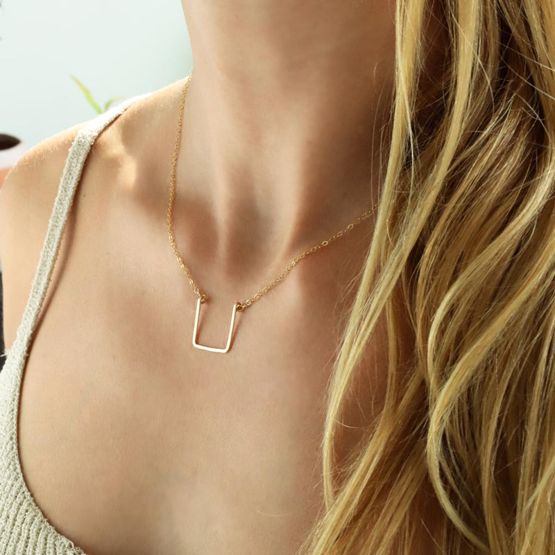 neckline with delicate geometric hammered pendant