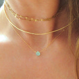 layered gold choker necklaces and small chalcedony pendant