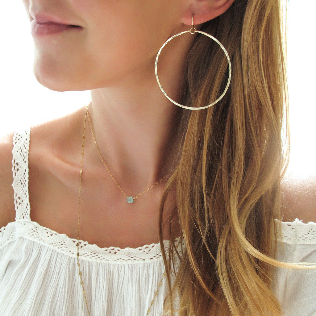 gold extra large round hammered hoop earrings handmade jewelry in williamsburg brooklyn by delia langan jewelry