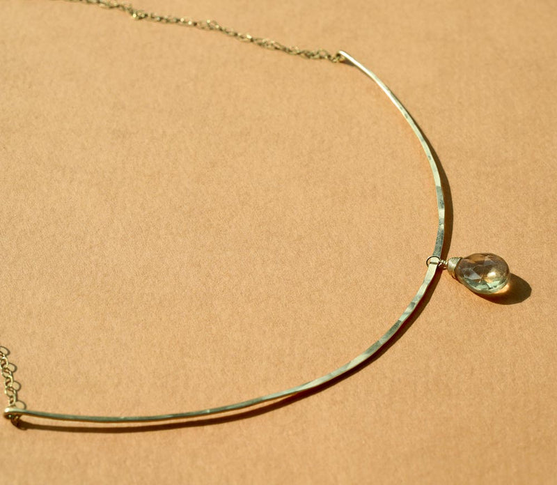champagne quartz and thin delicate gold arc necklace on orange background