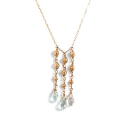 14k gold filled aquamarine tassel multi gemstone necklace on a white surface