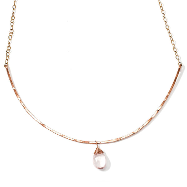 rose quartz gemstone collar necklace on a white surface 