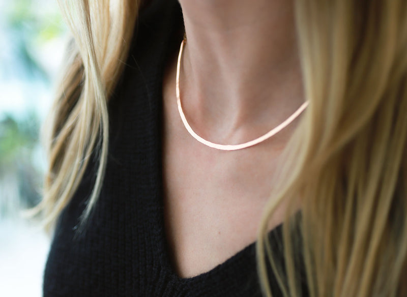 closeup of neckline with gold collar necklace