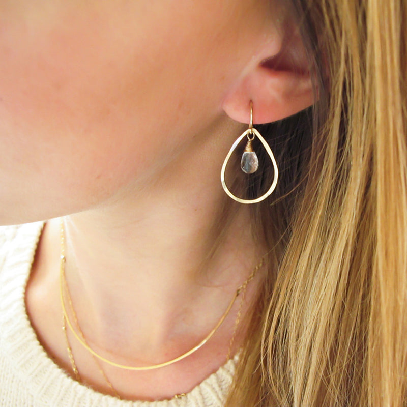 blond woman ear closeup wearing 14k gold filled crystal quartz teardrop gemstone hoops