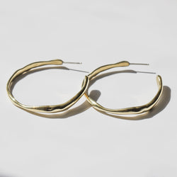 pair of gold irregular post back hoop earrings