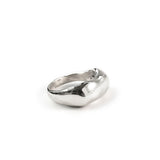 curve ring silver on white surface by delia langan jewelry