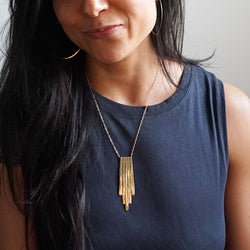 brunette wearing 14k gold filled chain empire pendant necklace and 14k gold filled horizon endless hoop earrings 