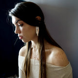 brunette wearing sterling silver empire earrings halo collar and tied up choker necklace