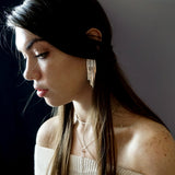 woman closeup wearing sterling silver empire earrings halo collar and tied up choker necklace