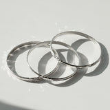 three silver bangles by delia langan jewelry
