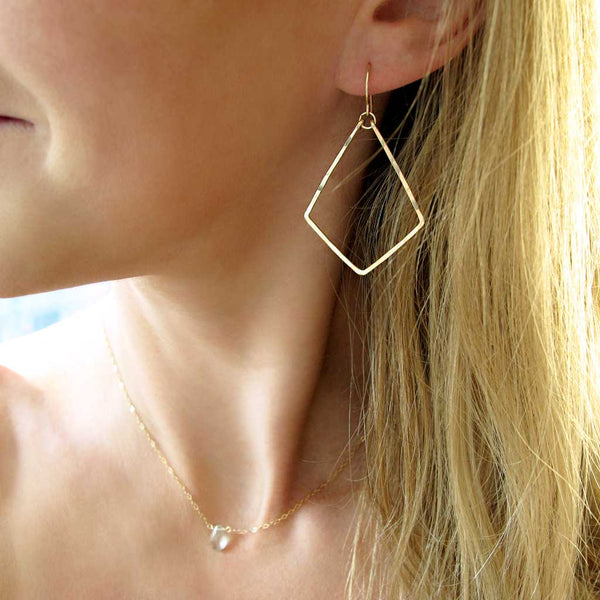 delicate geometric gold dangle earrings by delia langan jewelry