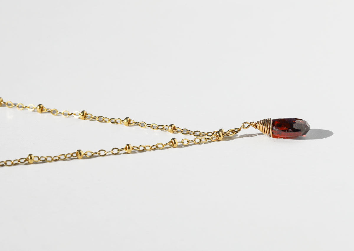 delicate gold garnet pendant