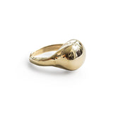 brass globe ring on white surface by delia langan jewelry