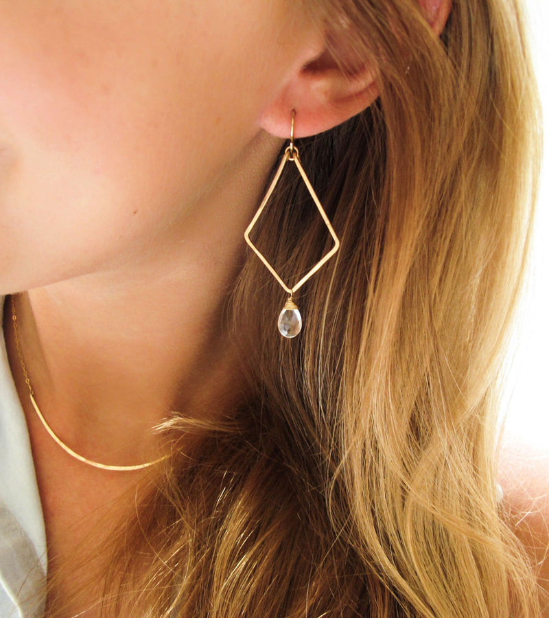 blond woman wearing 14k gold filled crystal quartz arrowhead gemstone earrings