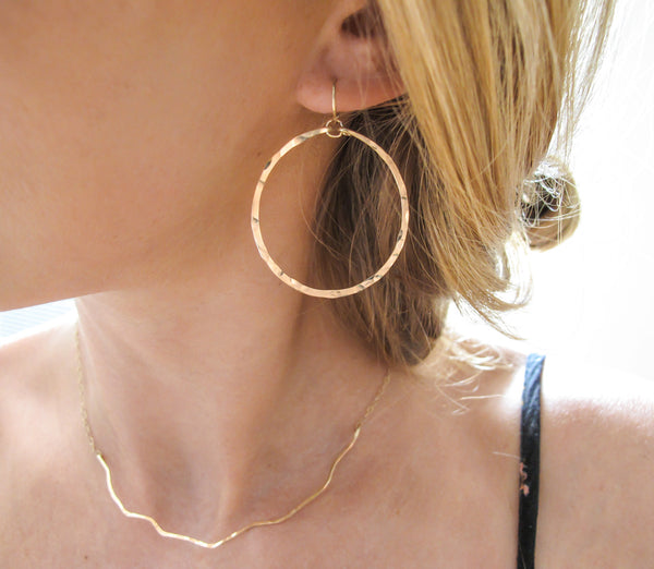 medium sized round hammered gold hoop earrings by delia langan jewelry