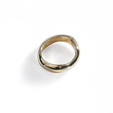 chunky gold ring on white background