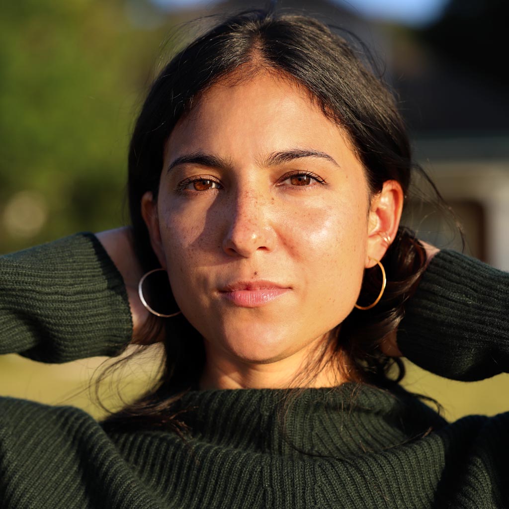 girl with small hoops against green background