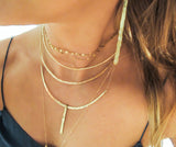 blond woman on a navy blue top neck closeup wearing a 14k gold filled halo collar