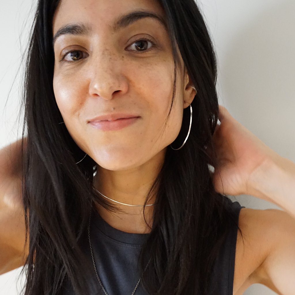 brunette closeup wearing sterling silver horizon endless hoop earrings and a sterling silver halo collar 