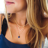gold geometric necklace layered with delicate blue lapis pendant