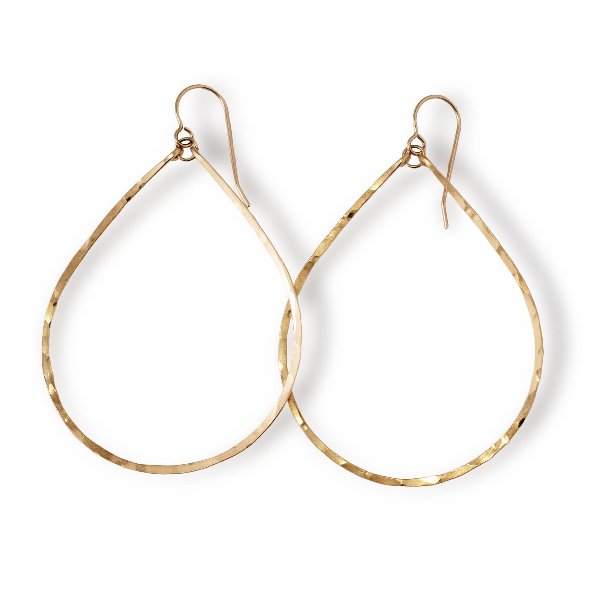 delicate large gold teardrop hoop earrings on white background