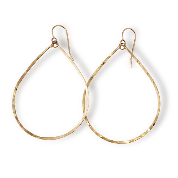 delicate large gold teardrop hoop earrings on white background