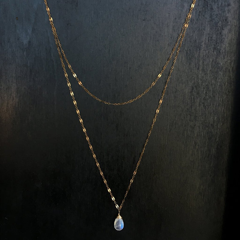 14k gold filled moonstone choker wrap gemstone necklace on a black wood surface