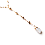 moonstone closeup of a 14k gold filled moonstone short y gemstone necklace reflecting light