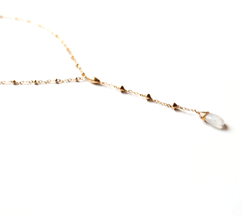 closeup of a 14k gold filled moonstone short y gemstone necklace under a bright light
