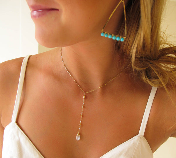 blond woman on a white top wearing a 14k gold filled moonstone short y gemstone necklace