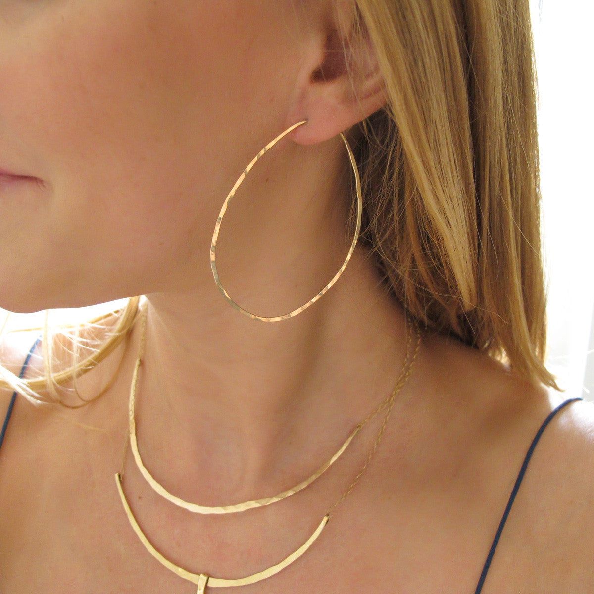 Oval Hoop Earrings shown in ear by delia langan jewelry