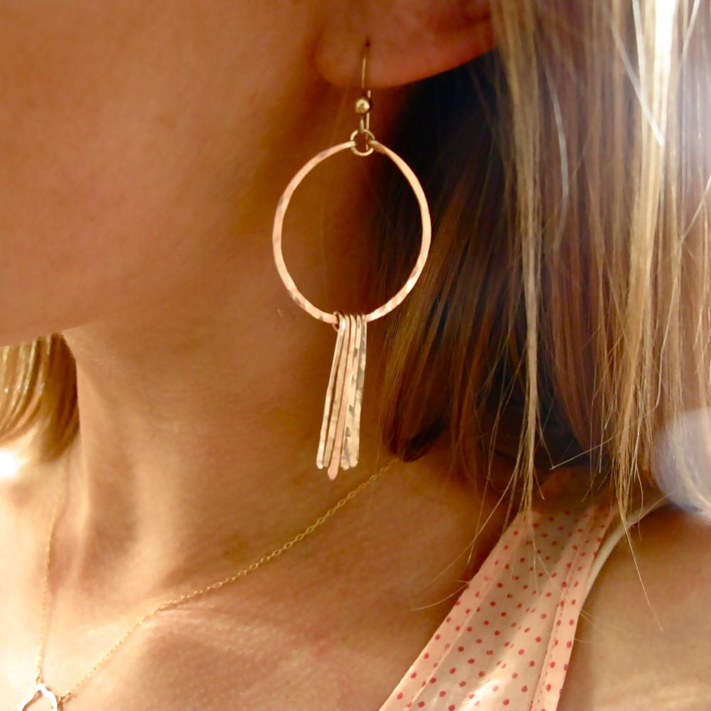 blond woman on a pink with red dots tank wearing rose gold filled round fringe hoop earrings
