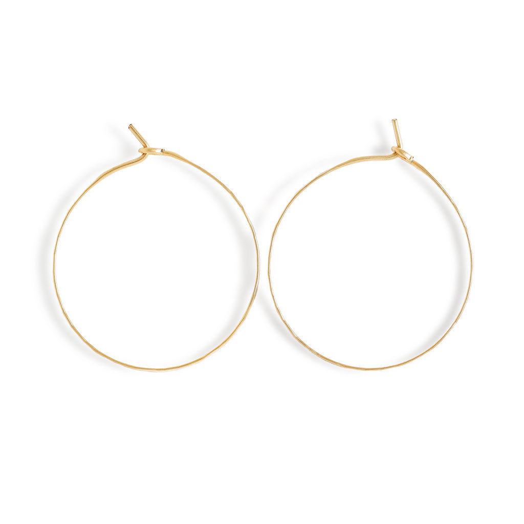 small 14k gold filled horizon endless hoop earrings on white surface 