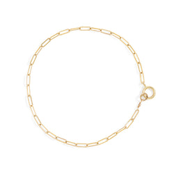 gold color small link chain bracelet on white surface