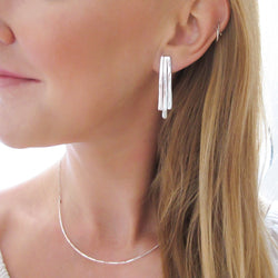 blond woman neck closeup wearing sterling silver small fringe post earrings 
