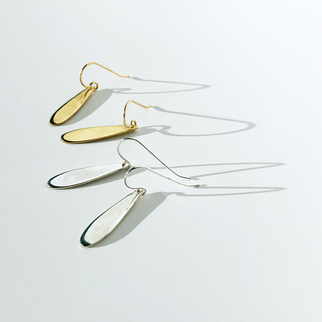 simple gold and silver teardrop earrings by delia langan