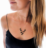 blond woman cleavage wearing 14k gold filled black spinel wingspan gemstone necklace