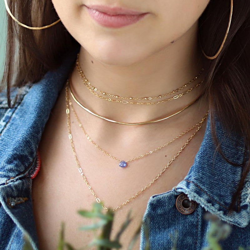 dainty tanzanite pendant and delicate gold layering necklaces