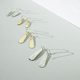 gold and silver teardrop earrings in different sizes by delia langan