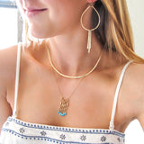 blond woman on a white and blue top wearing 14k gold filled teardrop fringe earrings