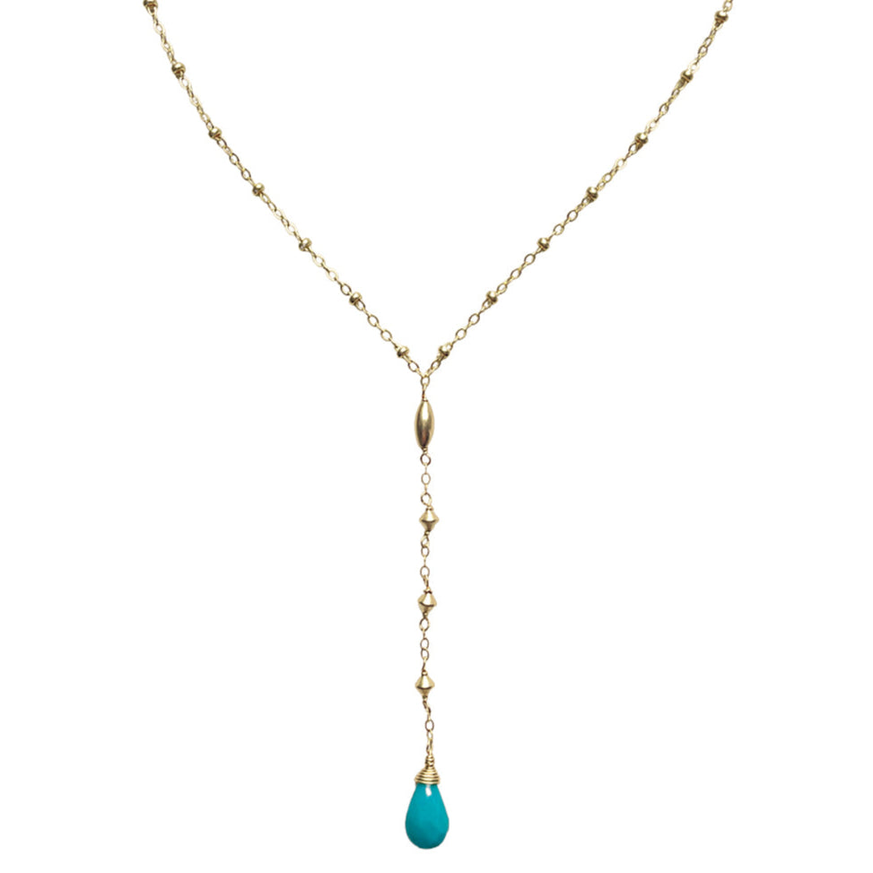 Gold necklace with a turquoise pendant on a white background