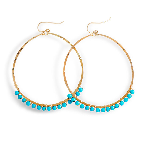 14k gold filled turquoise xl gemstone arc hoops on a white surface