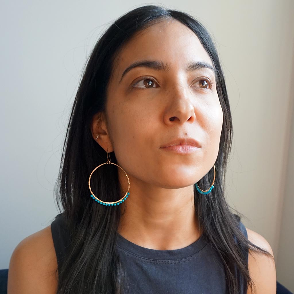 brunette looking up wearing 14k gold filled turquoise xl gemstone arc hoops 