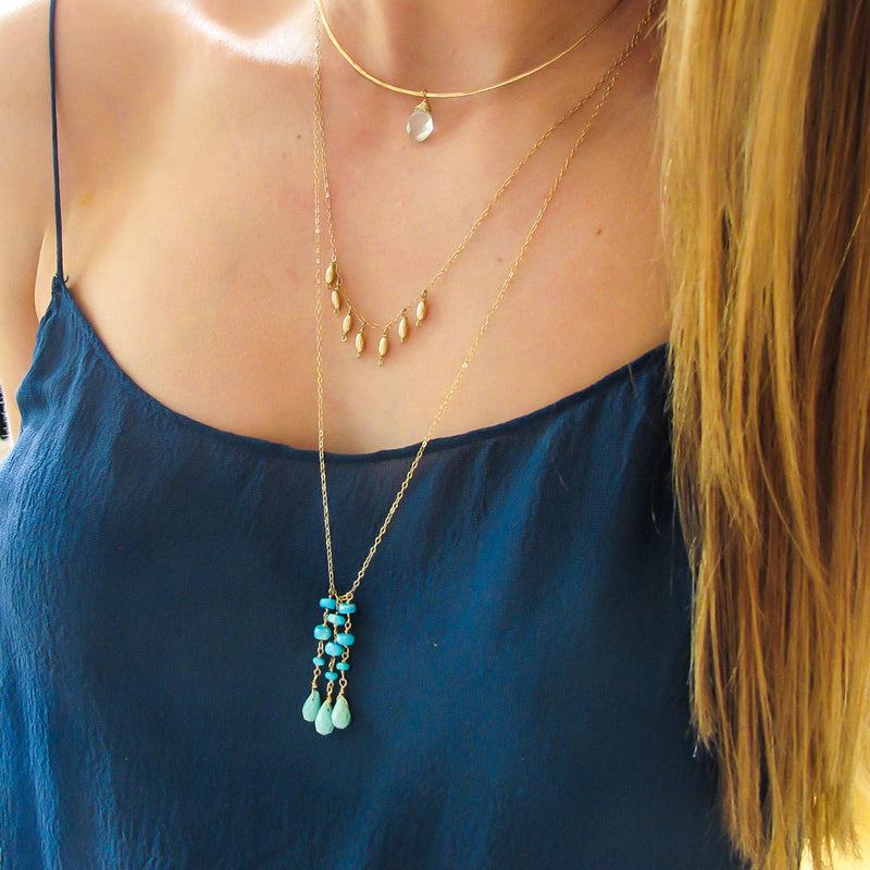 long turquoise necklace on gold chain by delia langan jewelry