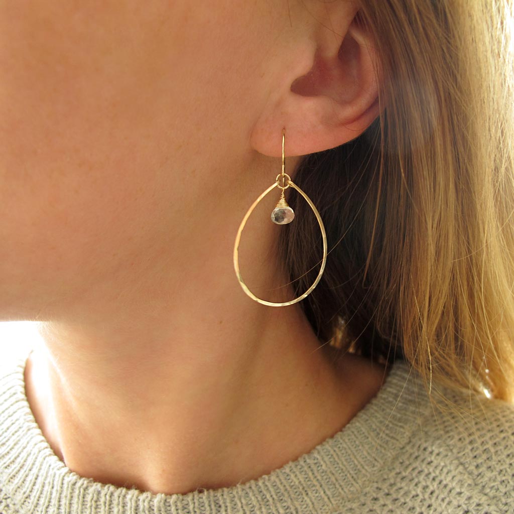 white topaz and thin gold oval hoop earrings