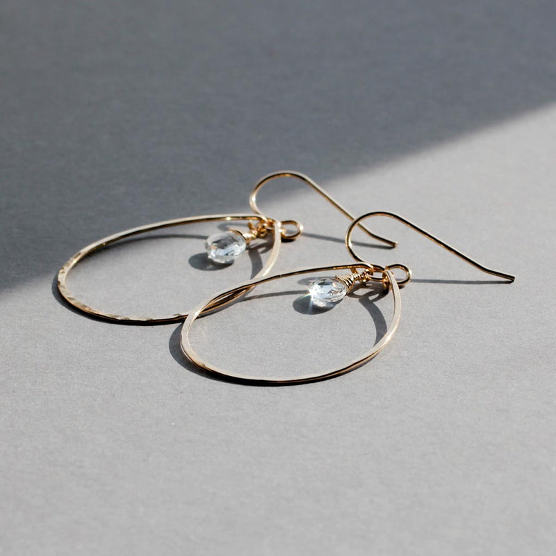 white topaz and thin gold oval hoop earrings